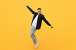 © Prostock-studio - Cheerful young stylish caucasian guy moving on yellow background