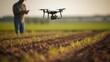 A birdseye view shows a farmer remotely operating a drone, using precision technology to precisely plant every seed and optimize crop spacing in agriculture operations.