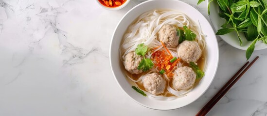 Poster - Rice vermicelli Noodle soup with pork balls in white bowl. with copy space image. Place for adding text or design