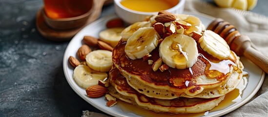 Leinwandbilder - Plantain buttermilk pancakes Soft and fluffy buttermilk pancake made with a batter added with slices of ripe plantain Served with chopped almonds sliced plantain and a drizzle of honey