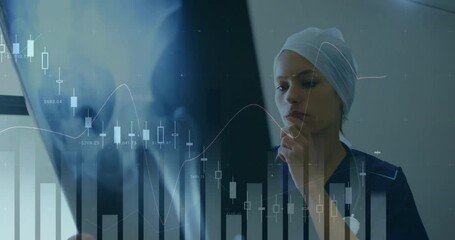 Canvas Print - Animation of financial data processing over caucasian female doctor