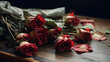 Bouquet of withered roses with their petals falling on a wooden table - copy space