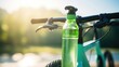 Closeup of a cyclists ecofriendly water bottle, filled with refreshing cold water, attached to their bicycles frame.