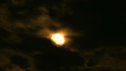 Wall Mural - huge orange full moon rises from behind cloudscape, time lapse
