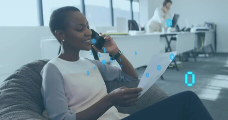 Canvas Print - Animation of binary data processing over african american woman talking on phone in casual office