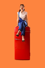 Sticker - Attractive pin-up worker sitting on retro fridge against orange background