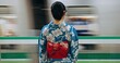 Japan woman, travel and train station in kimono and public transportation on metro bullet in city. Person, motion blur or traditional clothes by fast vehicle or subway in tokyo on urban adventure