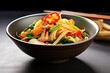 calamari and vegetable stir-fry in black asian bowl