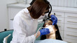 © Vladislav - Young female dentist during work process, close-up of young woman's dental treatment. Concept of healthy teeth and modern treatment in a dental clinic.