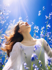 Wall Mural - Portrait of beautiful girl in field with bluebell flowers, sky background