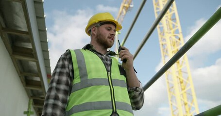 Aufkleber - Engineering, construction site and man with a walkie talkie talking for building development project. Industrial renovation, contractor or manager speaking of safety on a radio for communication