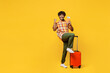 Traveler winner Indian man he wear casual clothes hold bag passport ticket isolated on plain yellow background. Tourist travel abroad in free spare time rest getaway. Air flight trip journey concept.