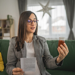 Wall Mural - Expectant woman read leaflet take tablets medication or supplement