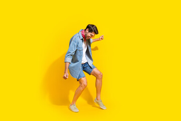 Poster - Full size photo of good mood guy wear jeans jacket shorts in sunglass dancing at summer party isolated on bright yellow color background
