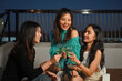 © Prathankarnpap - Happy female friends having fun drinking wine on rooftop dinner party. Friendship lifestyle concept