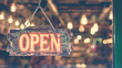 Open sign broad through the glass of door in cafe. Business service and food concept. Vintage tone filter color style.