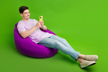 Canvas Print - Full length photo of happy nice man reading instagram twitter free wifi zone empty space isolated on green color background