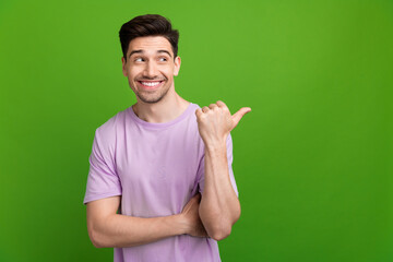 Wall Mural - Photo portrait of nice young male point look interested empty space dressed stylish purple garment isolated on green color background