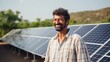 © JooLaR - A field of solar panels with a male worker, an energy specialist. Concept of clean solar energy, renewable resources. Background for advertising, business of solar systems.
