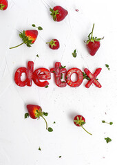 Wall Mural - word detox made from red strawberry on a white background, healthy eating, smoothie, food, fruit, tasty treat, healthy breakfast, weight loss, diet, nutrition