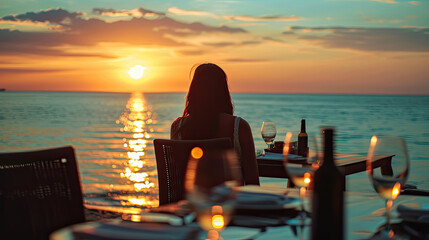 Sticker - Romantic dinner on sunset. Woman sitting alone on table set with lantern for a romantic meal on beach, yachts and ocean on background. Dinner for a couple in love in luxury outdoor restaurant