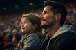 Their faces are illuminated by the field's lights, reflecting the joy and anticipation of the game. This heartwarming scene captures the essence of family bonding and the thrill of live sports