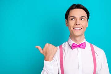 Wall Mural - Photo portrait of handsome young guy point look interested empty space dressed stylish pink garment isolated on aquamarine color background