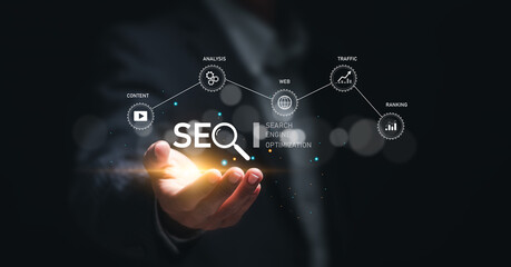 Businessman hold virtual SEO icon to analyze SEO search engine optimization for promoting ranking traffic on website and optimizing your website to rank in search engines.