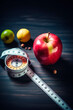 © Артур Комис - measuring tape apple on wooden table. Emaciation