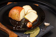Circassian Adyghe sliced smoked cheese on a black background