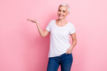 Sticker - Portrait of cheerful person with white hairdo dressed stylish t-shirt palm presenting offer empty space isolated on pink background