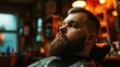 handsome brutal barber portrait in barbershop.