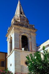 Wall Mural - Close-up view of ancient bell tower of San Giuseppe Church in Taormina, Sicily. Blue sky background. Architectural icon of the city of Taormina. Travel and tourism concept