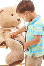 Boy Child, Teddy Bear And Stethoscope In Studio For Playing Doctor, Listening And Wellness By White Background. Kid, Healthcare Game And Development With Plushie Toys, Medical Check Or Consultation