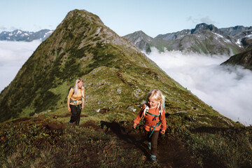 family hiking in mountains, child and mother traveling together adventure healthy lifestyle outdoor,