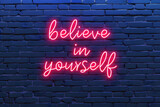 Fototapeta  - Neon sign with text believe in yourself on brick wall, motivational and inspirational quotes