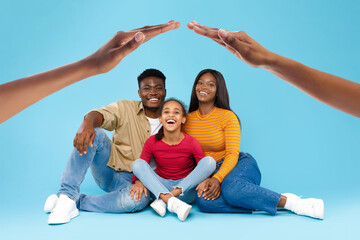 Wall Mural - A happy Black family, with a little daughter laughing joyfully