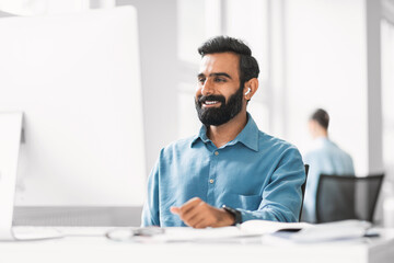 Aufkleber - Happy male professional with earphones working at his desk