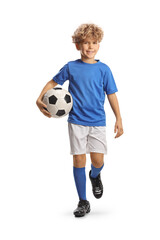 Poster - Full length portrait of a boy in a football kit walking and carrying a ball