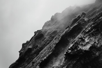Poster - A black and white photo of a rock face. Suitable for various uses