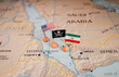 Flags of the USA and Iran surrounding a pirate insignia onto a map of the Red Sea region. It symbolically represents the intricate geopolitical dynamics and potential conflicts in this strategic