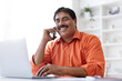 © Prostock-studio - Closeup middle aged indian man working from home office