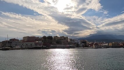 Wall Mural - Chania with the amazing lighthouse, mosque, venetian shipyards, at sunset, Crete, Greece.