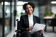 Confident Businesswoman in a Wheelchair Using Technology in the Office