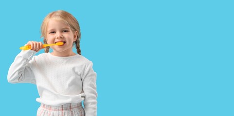 Sticker - Cute little girl brushing teeth on light blue background with space for text