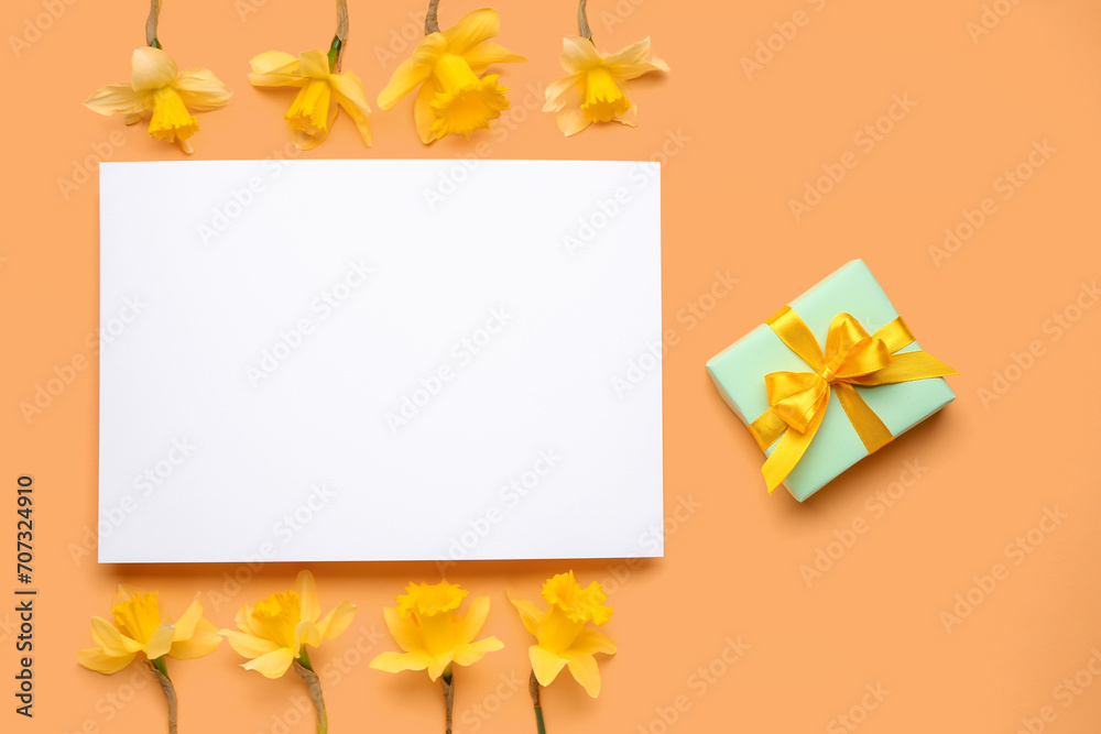 Beautiful narcissus, gift box and rectangular blank card on color background