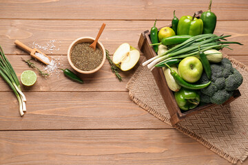 Wall Mural - Composition with different fresh green vegetables in box on wooden background