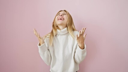 Wall Mural - Exuberant blonde girl screams in victorious joy, basking in her exciting win! exultantly standing on a pink, isolated background, her happiness goes over the top.