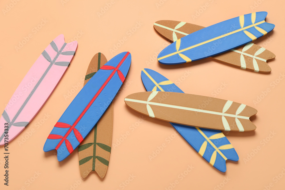 Different mini surfboards on orange background