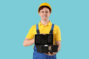 Poster - Male electrician with bag of tools on blue background